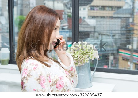 asian woman wearing Pajamas with smartphone
