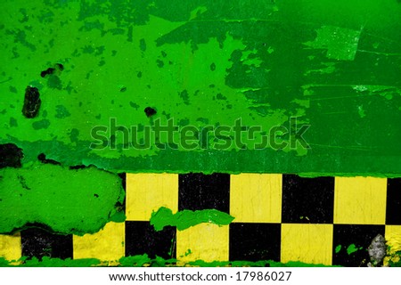 green peeling paint with checkered tape background