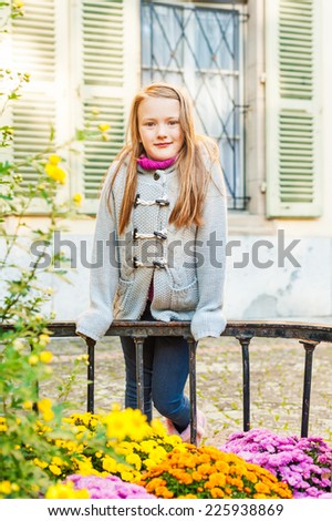 Outdoor portrait of a cute little girl in a city on a nice day