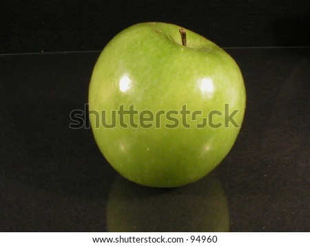 Granny Smith apple with black background.
