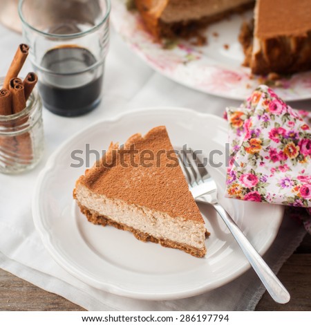 A Slice of Spiced Coffee Cheesecake Dusted with Cocoa Powder, square