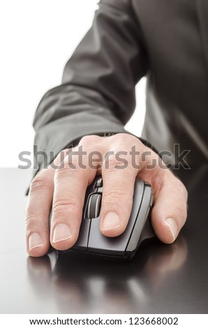 Male hand using a computer mouse on a black table.