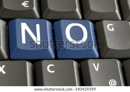 Word NO written with blue keys on computer keyboard.
