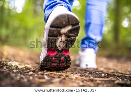 Detail of walking in the woods. Closeup of woman\'s step.