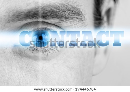 Close up greyscale image of a male eye with selective blue color to the iris and the word - Contact - in a bright ray of light incorporating the iris as the O, conceptual image.