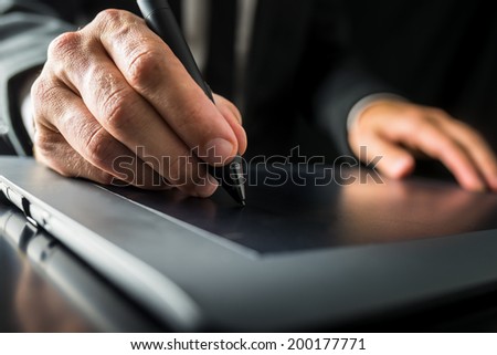Closeup of graphic designer using digital tablet to do his work.