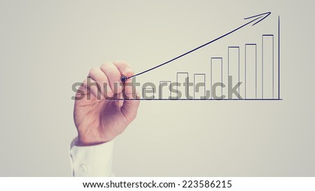 Man drawing an ascending bar graph on a virtual interface conceptual of analysis, performance growth and planning, vintage effect with copyspace.