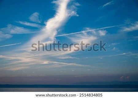 Vapour trails in the evening cloudy sky