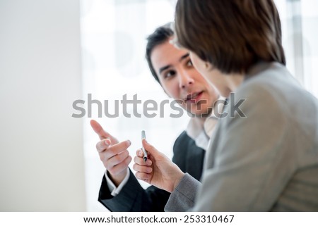 Businesswoman offering a pen to her business partner in order to close the deal with a signature. Focus on a pen.