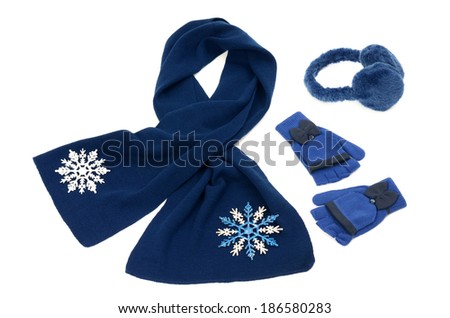 Dark blue winter accessories isolated. Wool scarf, a pair of gloves and earmuffs nicely arranged on white background.