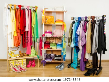 Wardrobe with summer clothes nicely arranged. Dressing closet with color coordinated  clothes and accessories on hangers and a shelf.