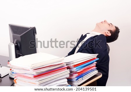 Tired business man sleeping at work. Exhausted worker sleeping at the desk.