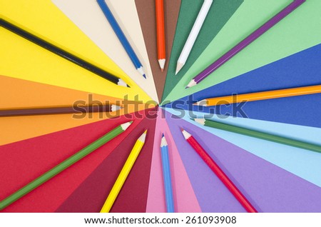 Color pencils on paper. All colors pencils arranged in a circle on rainbow color paper.