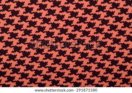 Orange and black houndstooth pattern. Dogstooth check design as background.