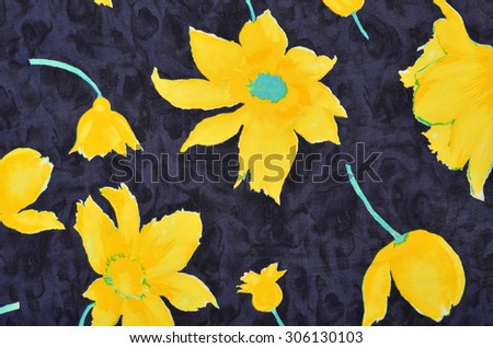 Floral pattern on blue fabric. Big yellow flowers print as background.