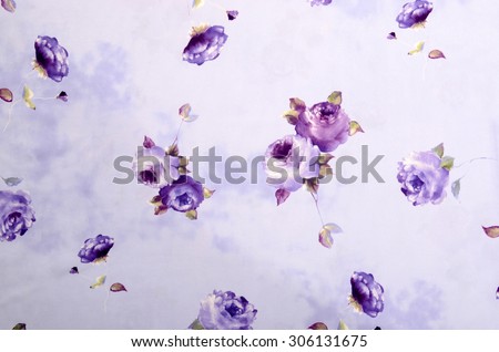 Floral pattern on purple fabric. Mauve rose flower print as background.