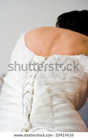 detail of the back of the brides bridal dress with decoration