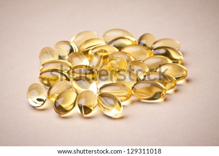 Cod liver oil omega 3 gel capsules isolated on pastel background