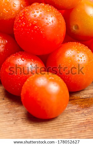 fresh Red tomatoes on wooden table with water drops