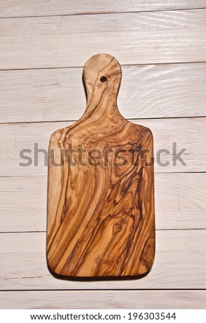 Olive wood cutting board on rustic background