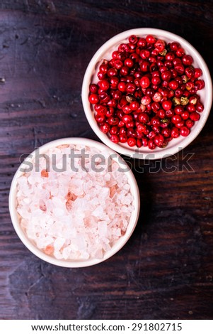 himalayan salt and red grain of pepper on wooden spoons