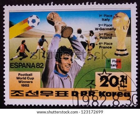 KOREA - CIRCA 1982: A stamp printed in Korea shows a winner of football championship with a cup in his hands, circa 1982.