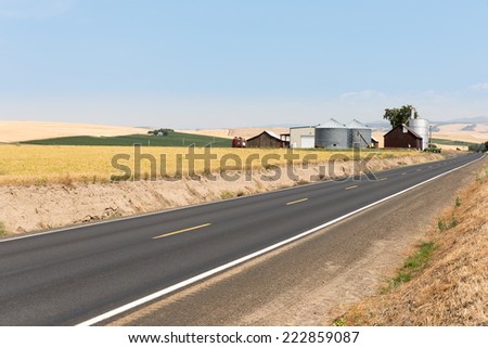 Road in eastern WA near Walla Walla approaching farm and barn with silo