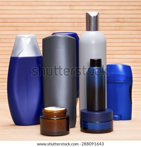 Mens cosmetics. Various cosmetic products for men on a wooden surface