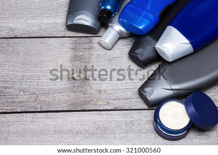 Mens cosmetics background. Various cosmetic products for men on old wooden planks. Copy space