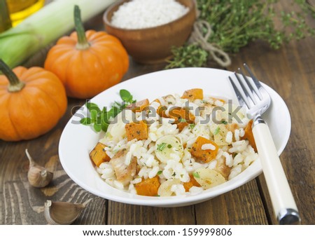 Risotto with chicken, pumpkin and leek in a bowl on the table