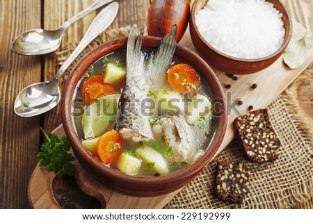 Homemade soup of river fish in the bowl on the table