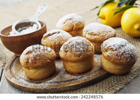 Lemon muffins with sugar powder on the wooden table