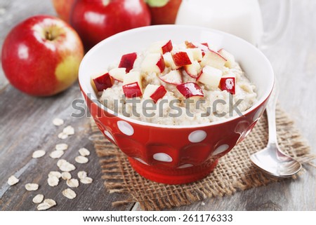 Oatmeal with apples in the orange bowl