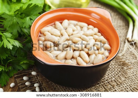 Bean stew in the ceramic pot on a table