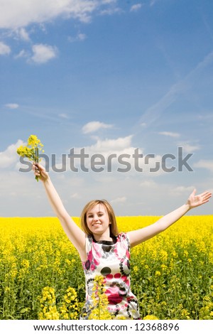 Outdoor freedom / Woman spreading her arms in the middle of a rapeseed field