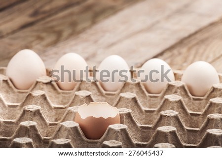 Eggs chicken on a wooden background in a paper tray, nobody.