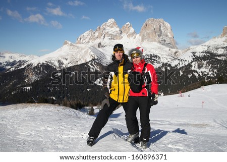 Two persons on a mountain-skiing slope, Dolomites, Italy