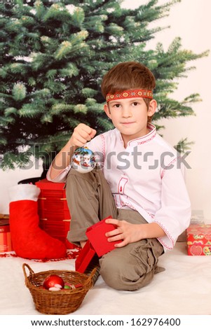 The boy with christmas presents in Slavic style