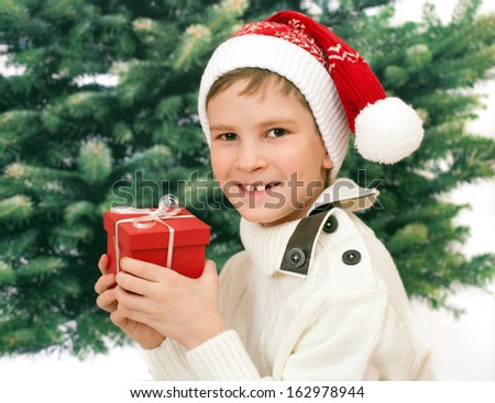 The child in red hood with New Year present