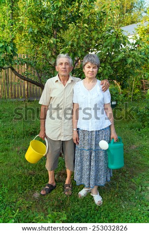 older gardeners with a pail and watering can