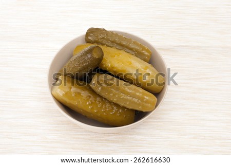 pickles in a bowl on beige tablecloths
