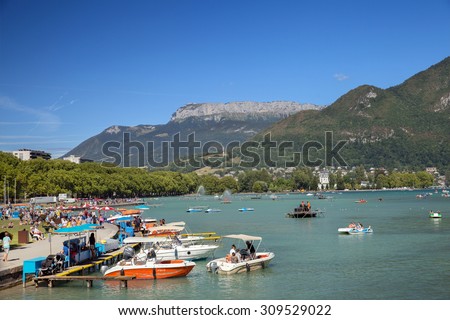 ANNECY, FRANCE - JULY 28, 2015: Napoleon III quay on Annecy lake with boat landing stage