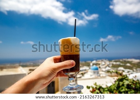 Frappe cold coffee in a hand on Santorini island in Greece. Photo stock © 