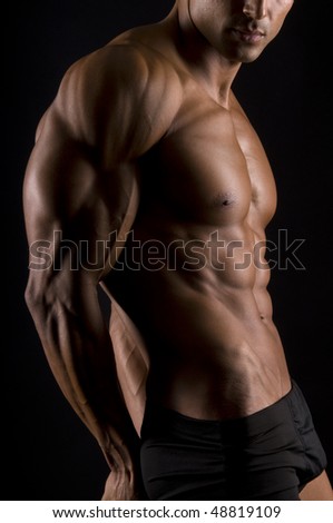 The male body on black background.