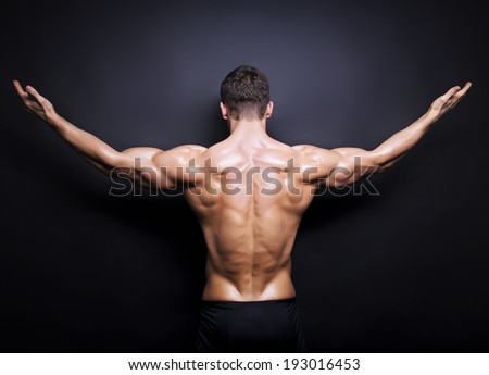 Muscular male back on black background in black and white