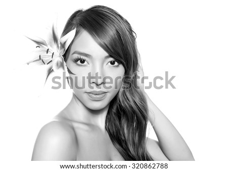 portrait of beautiful young asian woman with clear skin and lily isolated white