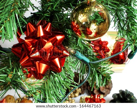 An image showing the spirit of Christmas with a red ribbon in a tree / Red ribbon in a tree