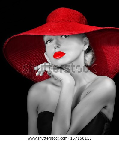 beautiful woman in hat  with red lips posing before camera