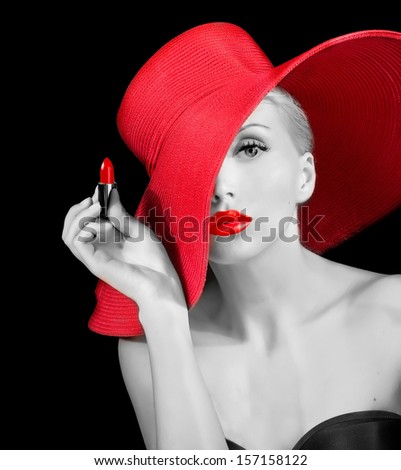 beautiful girl with red lipstick in hand wearing red hat black and white picture