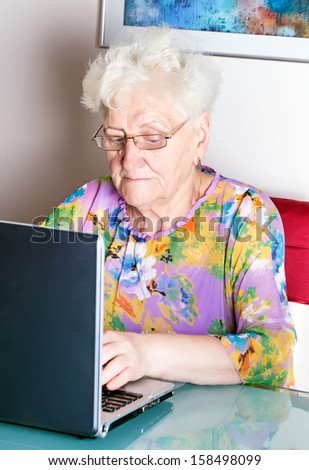 old woman using computer .